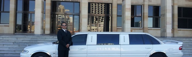 white limo and a man in black tuxedo