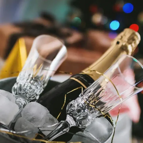 Bucket with champagne and glass